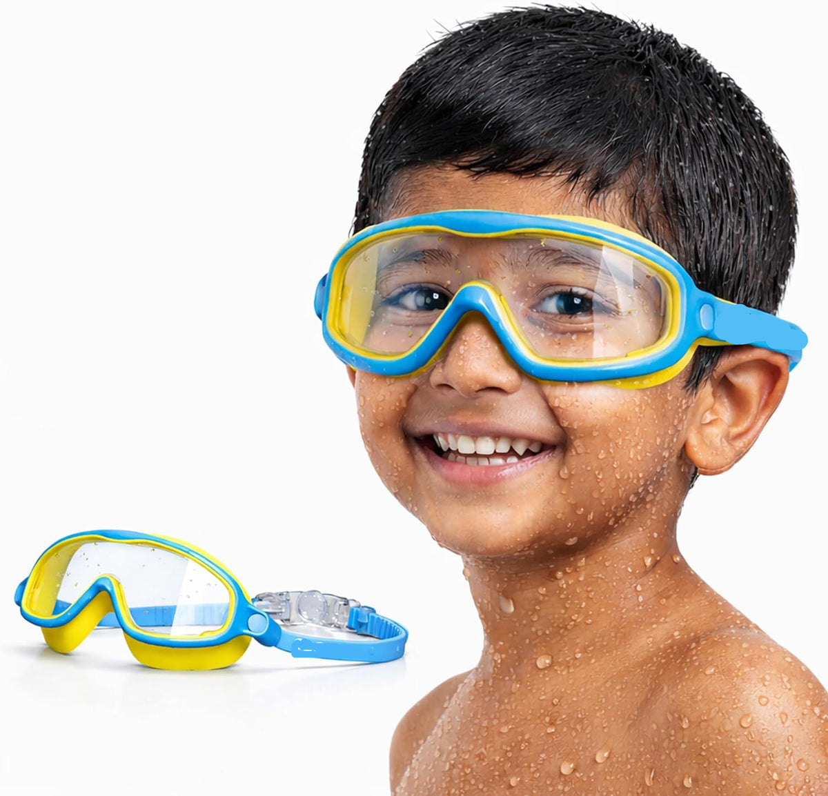 A smiling young boy wearing blue and yellow SLOVIC swim goggles, with a second pair of the same goggles resting on the surface below him, against a clean white background.