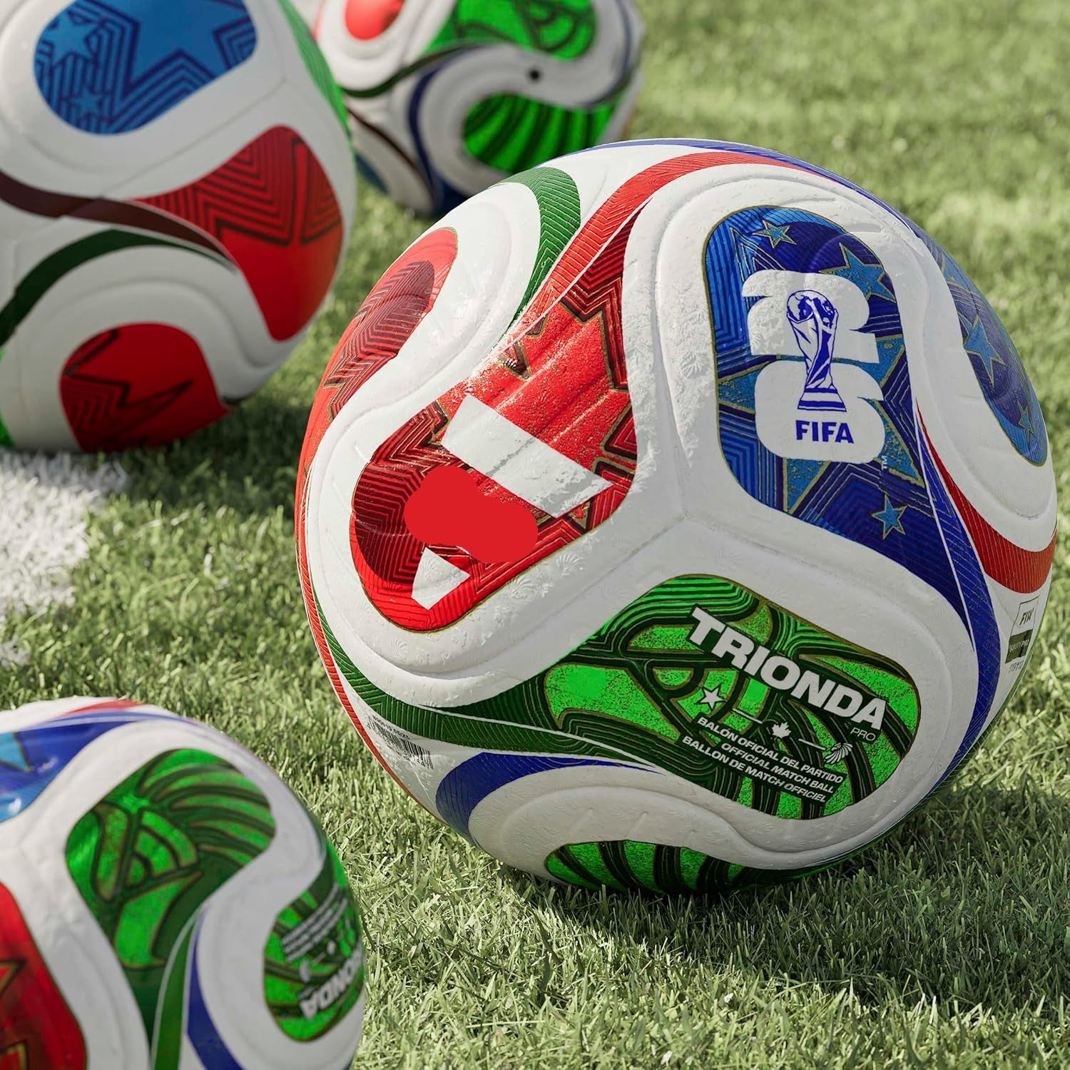Colorful soccer balls with FIFA and Trionda branding on a grass field