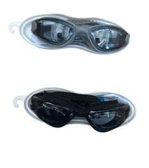 Two pairs of swim goggles resting on a beige stone surface, one in a white case and one in a gray case. The top pair has a gray frame and dark lenses, and the bottom pair has a black frame and dark lenses.